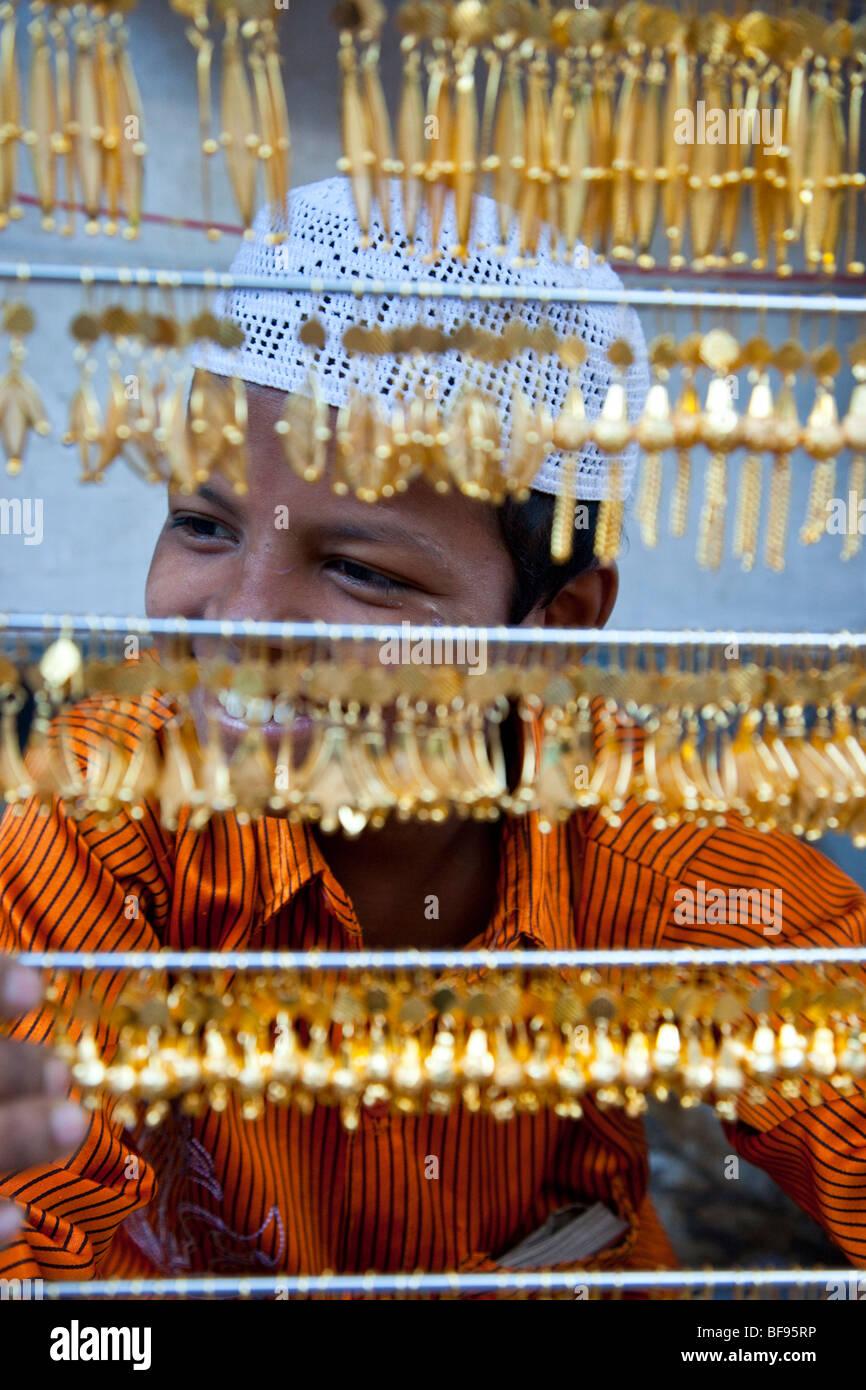 Muslim boy selling gold jewelry in Ajmer in Rajasthan India Stock Photo