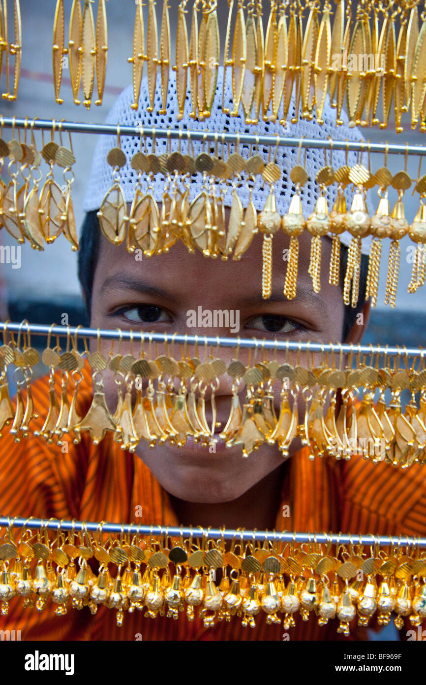 Muslim boy selling gold jewelry in Ajmer in Rajasthan India Stock Photo