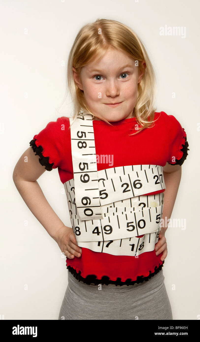 Little girl, with giant tape measure wrapped around her Stock Photo Alamy