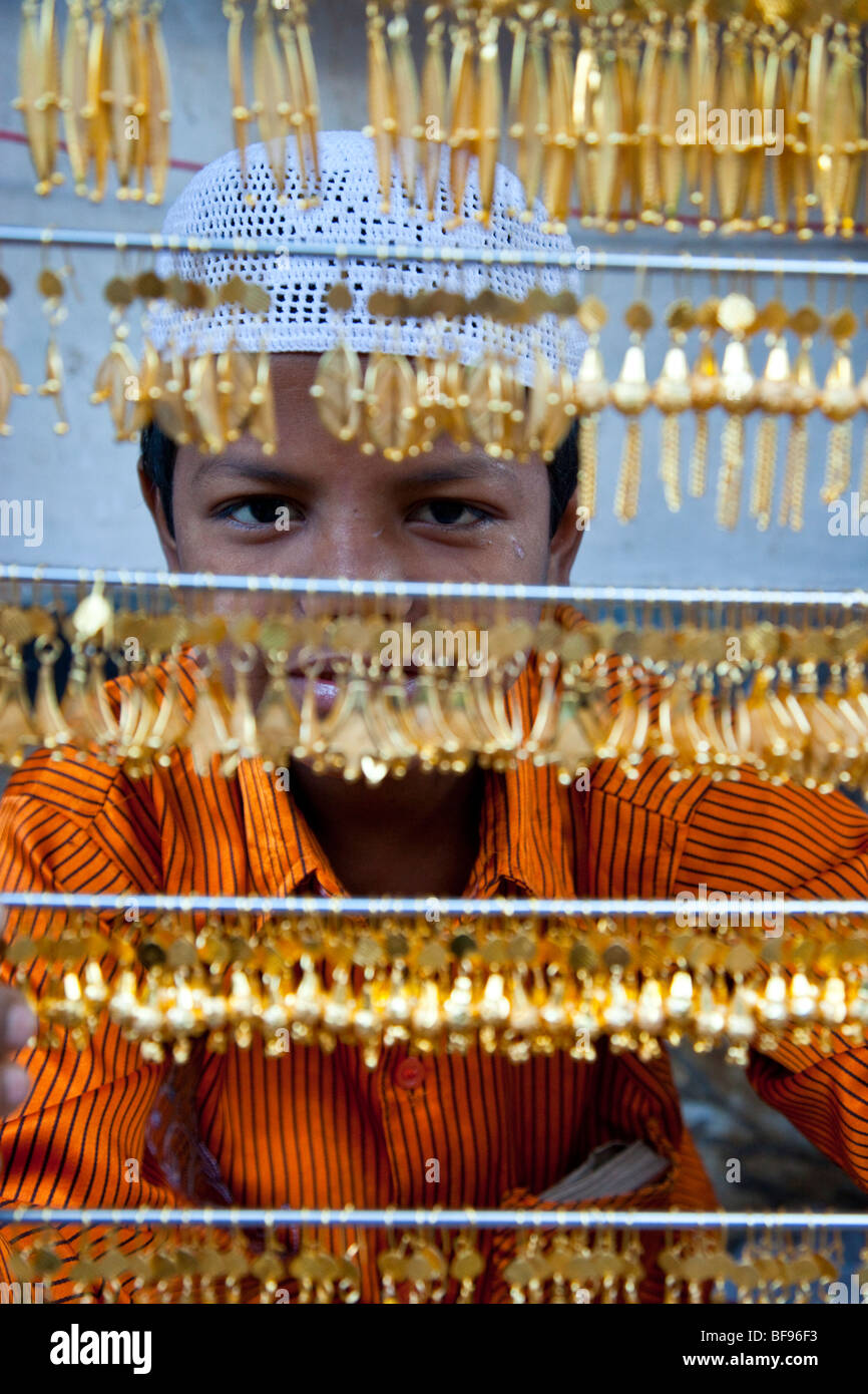 Muslim boy selling gold jewelry in Ajmer in Rajasthan India Stock Photo