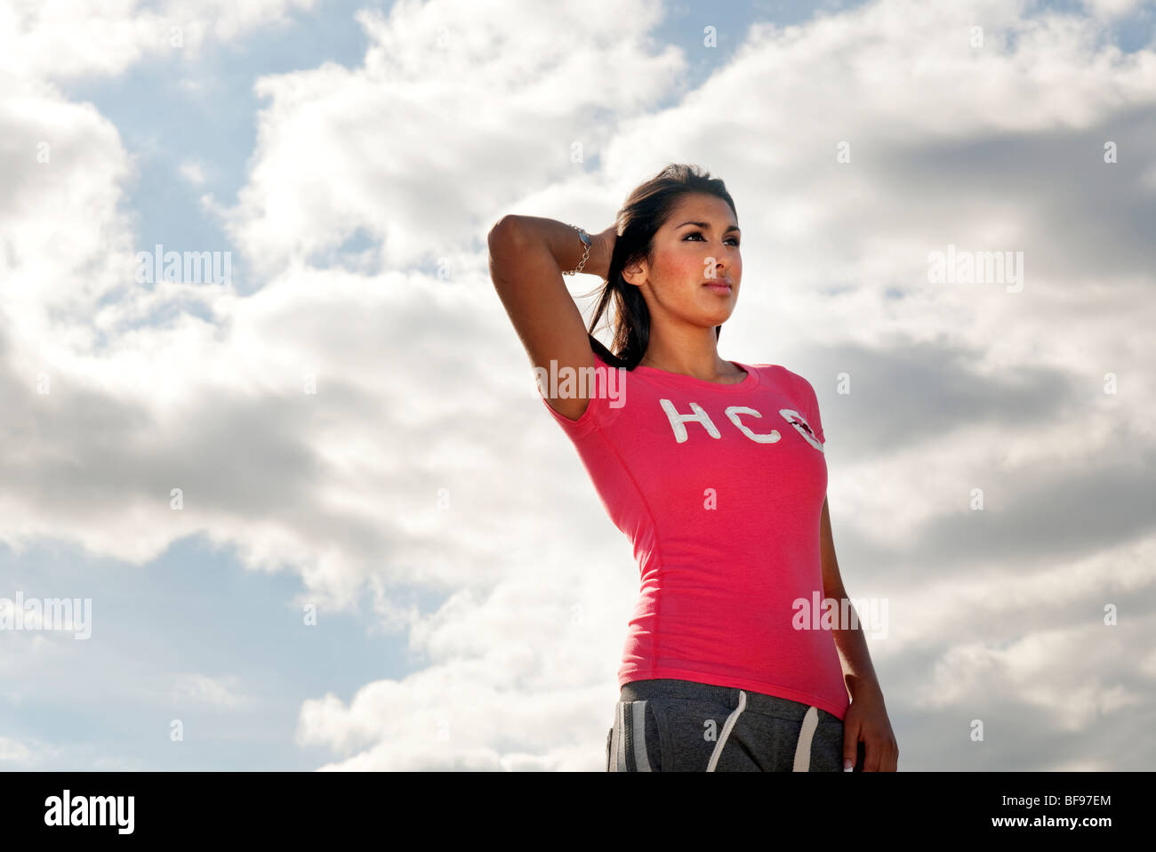 woman outdoors holding hair back out of her face Stock Photo