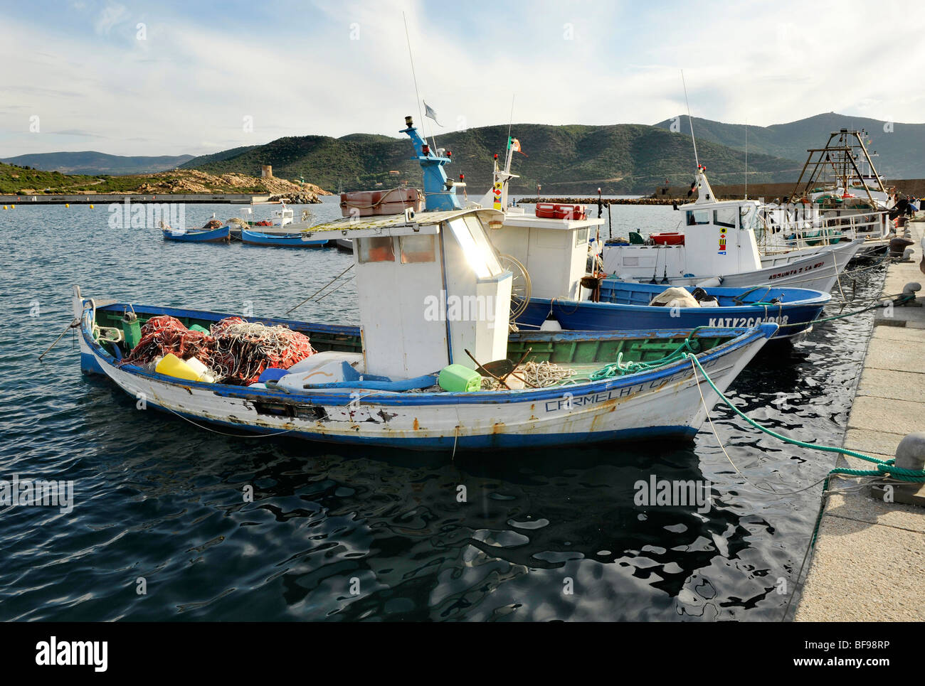 Small traditional fishing fleet moored on quayside in Teulada, South West Sardinia, Italy Stock Photo