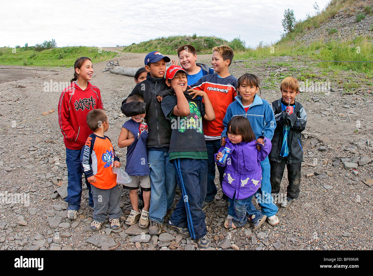Boys and girls greet boat at Tsiigehtchic, native village along Mackenzie River, NWT, Canada Stock Photo