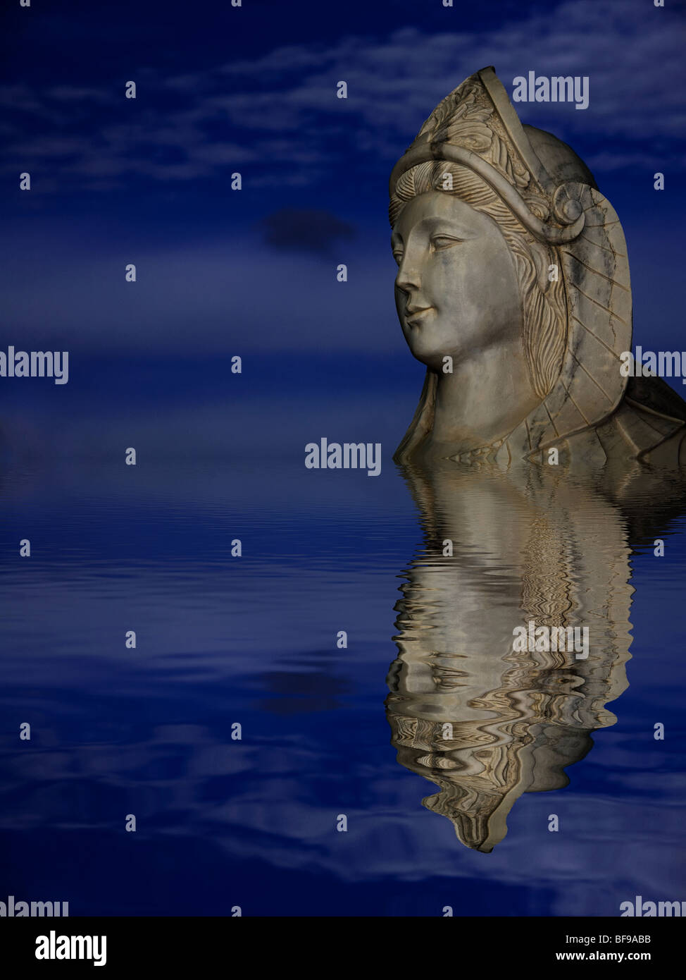 Statue reflected on the water with dark blue sky on the background Stock Photo