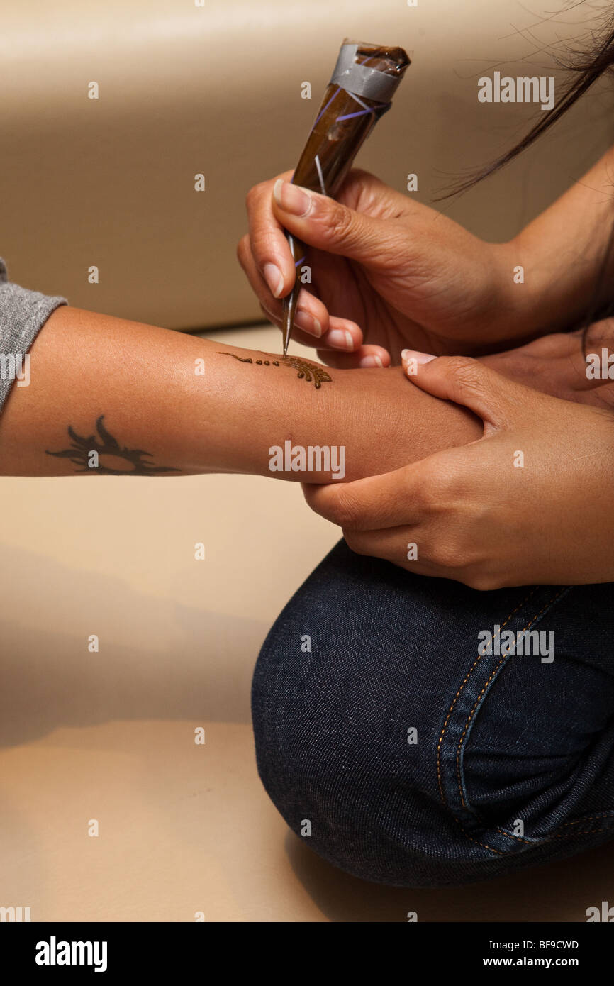 Applying henna on hand Stock Photo