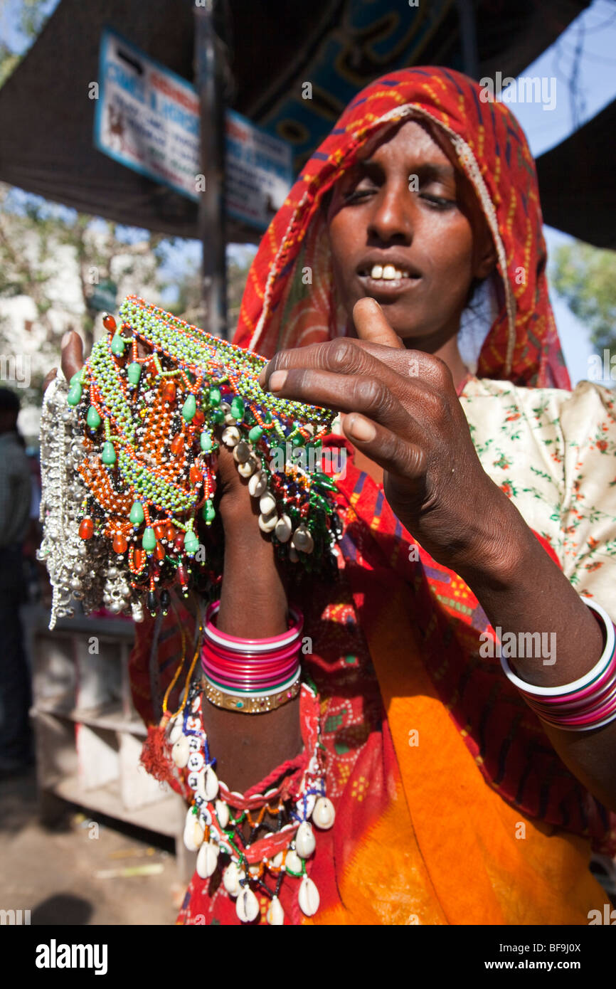 Woman selling jewelry at the Camel Fair in Pushkar in Rajasthan India Stock Photo