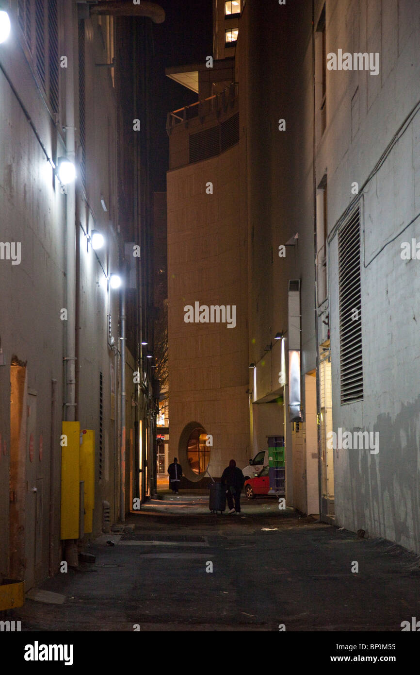 People walking in dark alley at night, Seattle, Washington Stock Photo