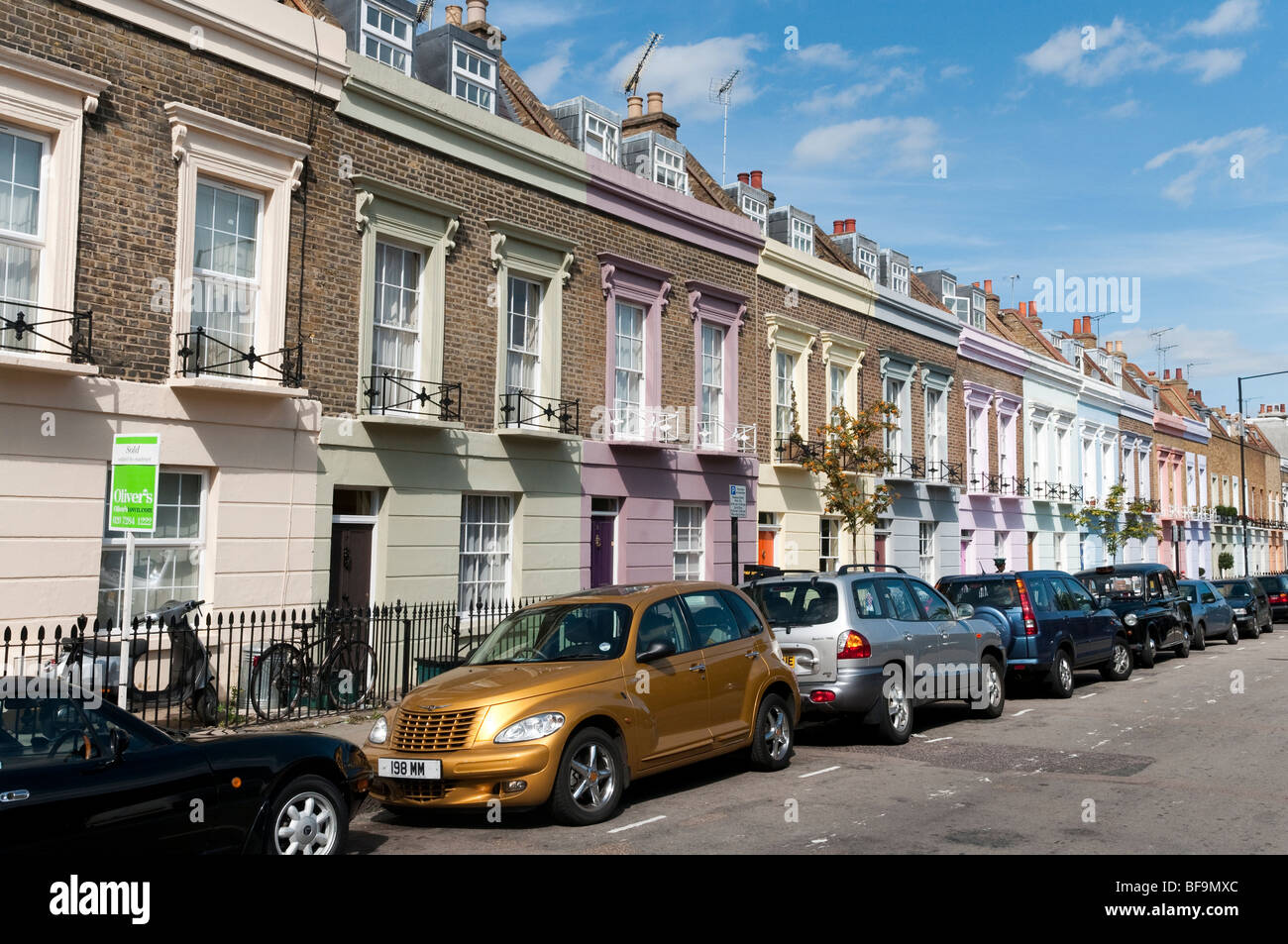Row of colourful terraced houses on Hartland Road in Camden, London, England, UK Stock Photo