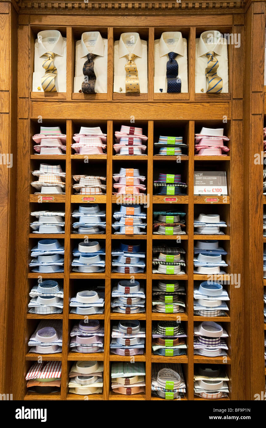 Men's shirts on shelves in T.M. Lewin clothes shop, London, England, UK Stock Photo