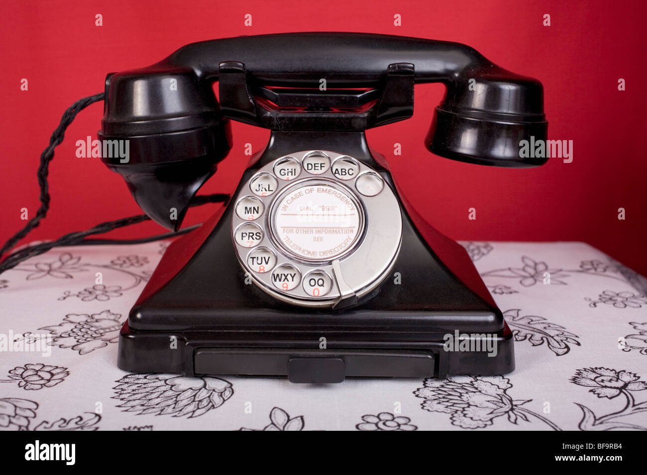 1940s Bakelite telephone against a red wall Stock Photo Alamy