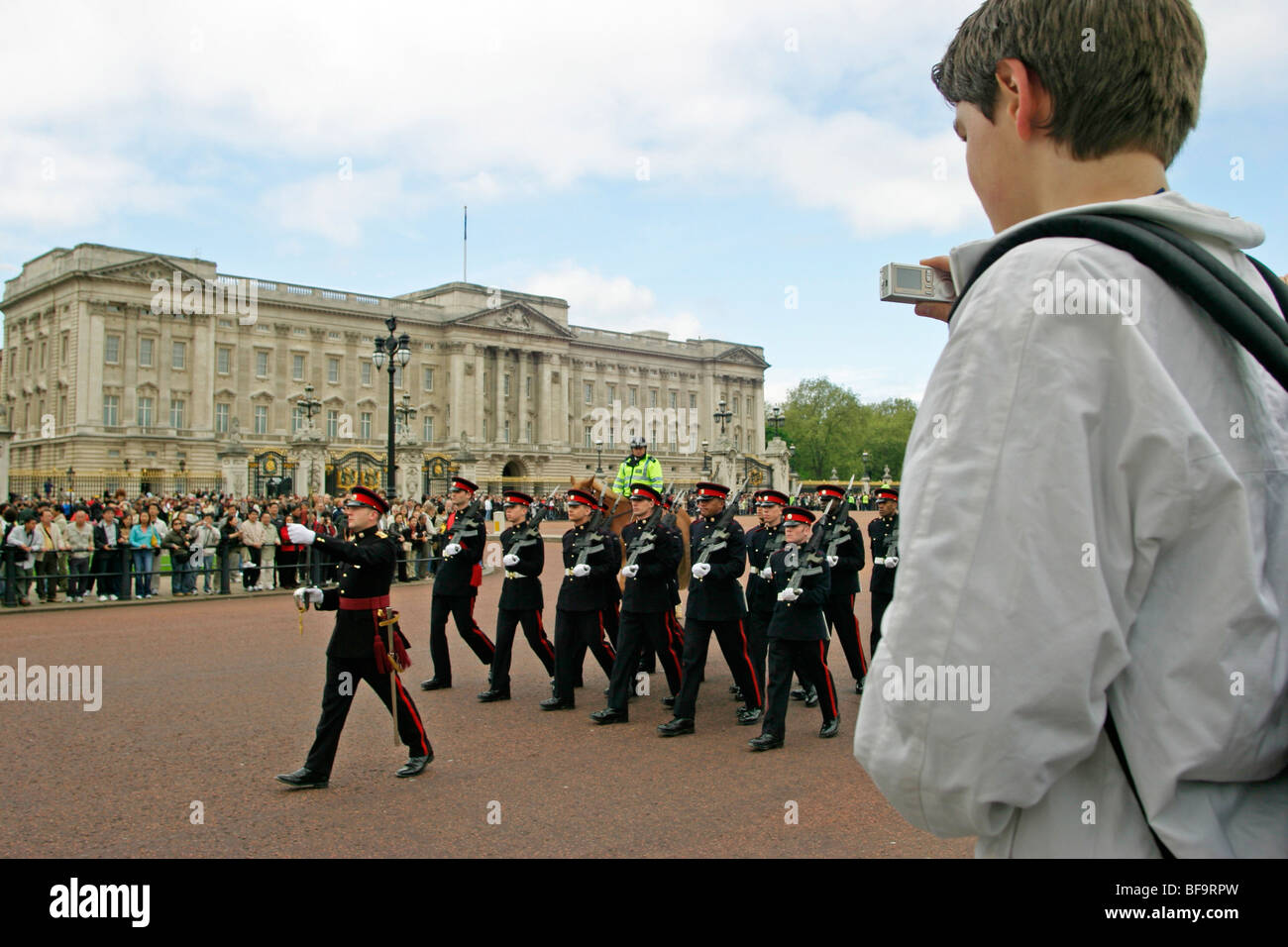young boy taking pictures of the Changing of the Guard in front of Buckingham Palace, London, Great Britain Stock Photo