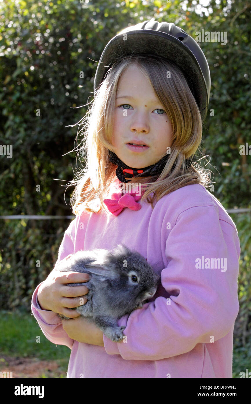 portrait of a young girl holding a rabbit Stock Photo - Alamy