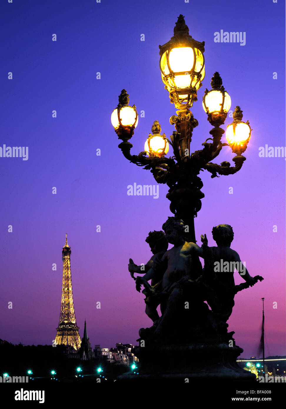 Eiffel Tower at night and ornate street lamp on Pont Alexandre 111 ...