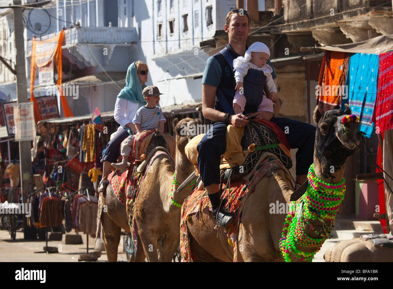 Tourists riding camels during the Camel Fair in Pushkar India Stock Photo