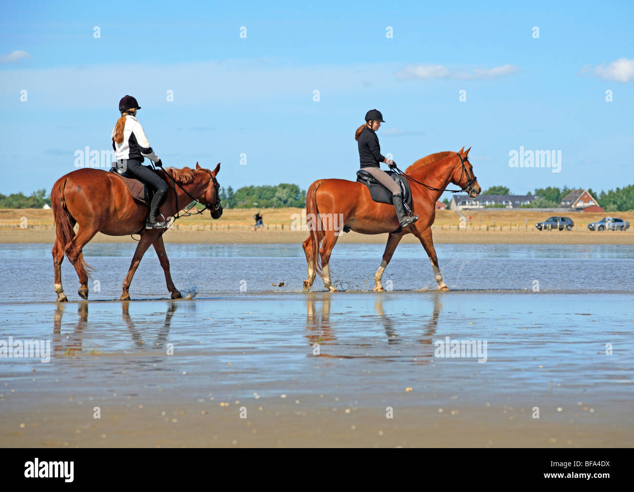 young women riding along the beach of St. Peter-Ording, Schleswig-Holstein, Germany Stock Photo