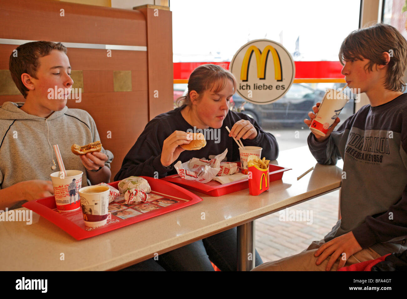 three teenagers at a McDonalds Restaurant Stock Photo