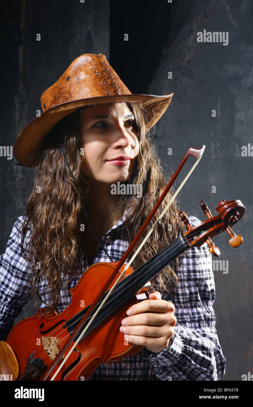 Beautiful violinist country performer on black background Stock Photo