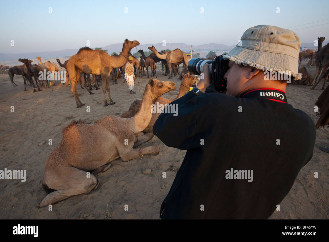 Wealthy Indian man taking pictures at the Camel Fair in Pushkar India Stock Photo