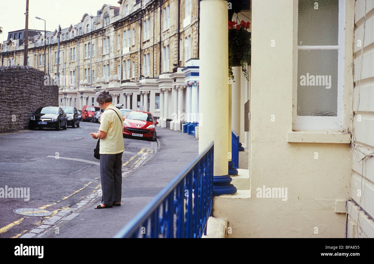 Woman outside a hotel in Claremont Crescent Weston Super Mare Somerset UK Stock Photo