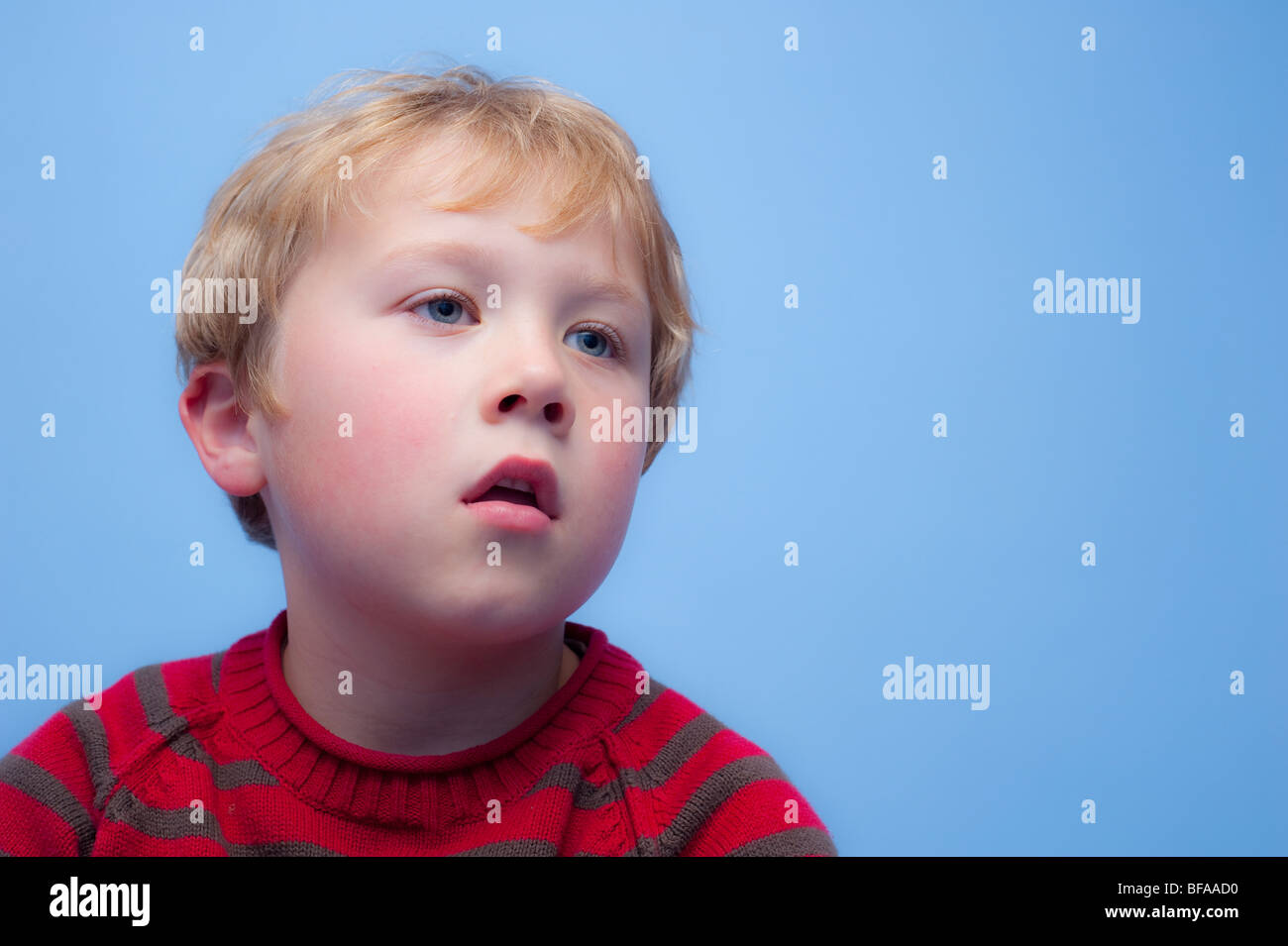 A Model Released picture of a six year old boy watching TV indoors in