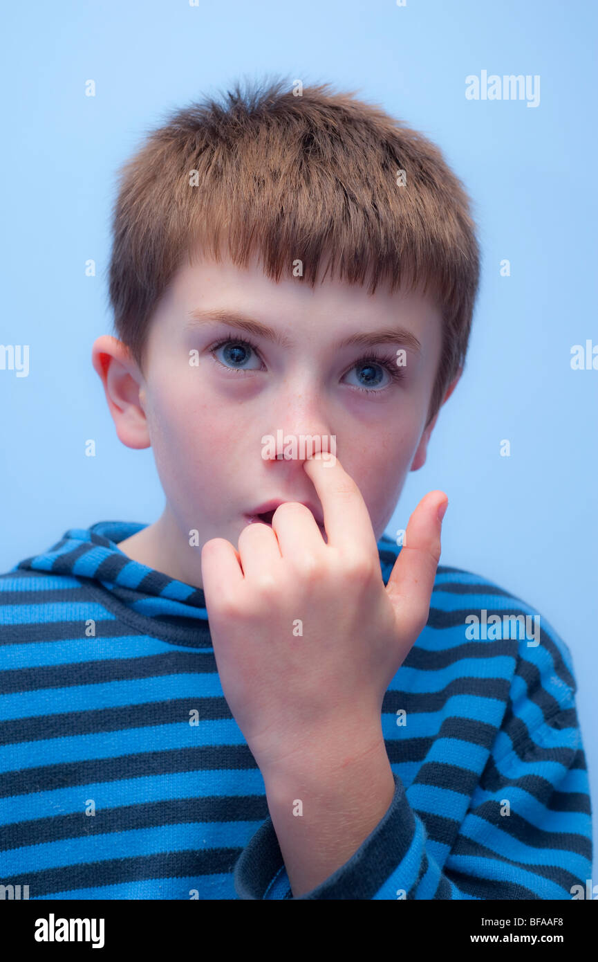 A Model Released picture of a ten year old boy picking his nose in his  bedroom in the Uk Stock Photo - Alamy