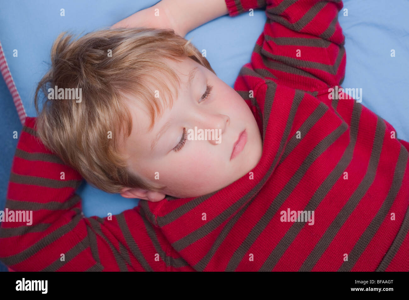 A Model Released picture of a six year old boy watching TV indoors in the Uk Stock Photo