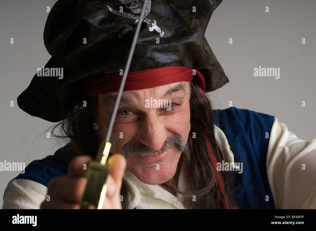 studio portrait of a pirate holding a sword Stock Photo