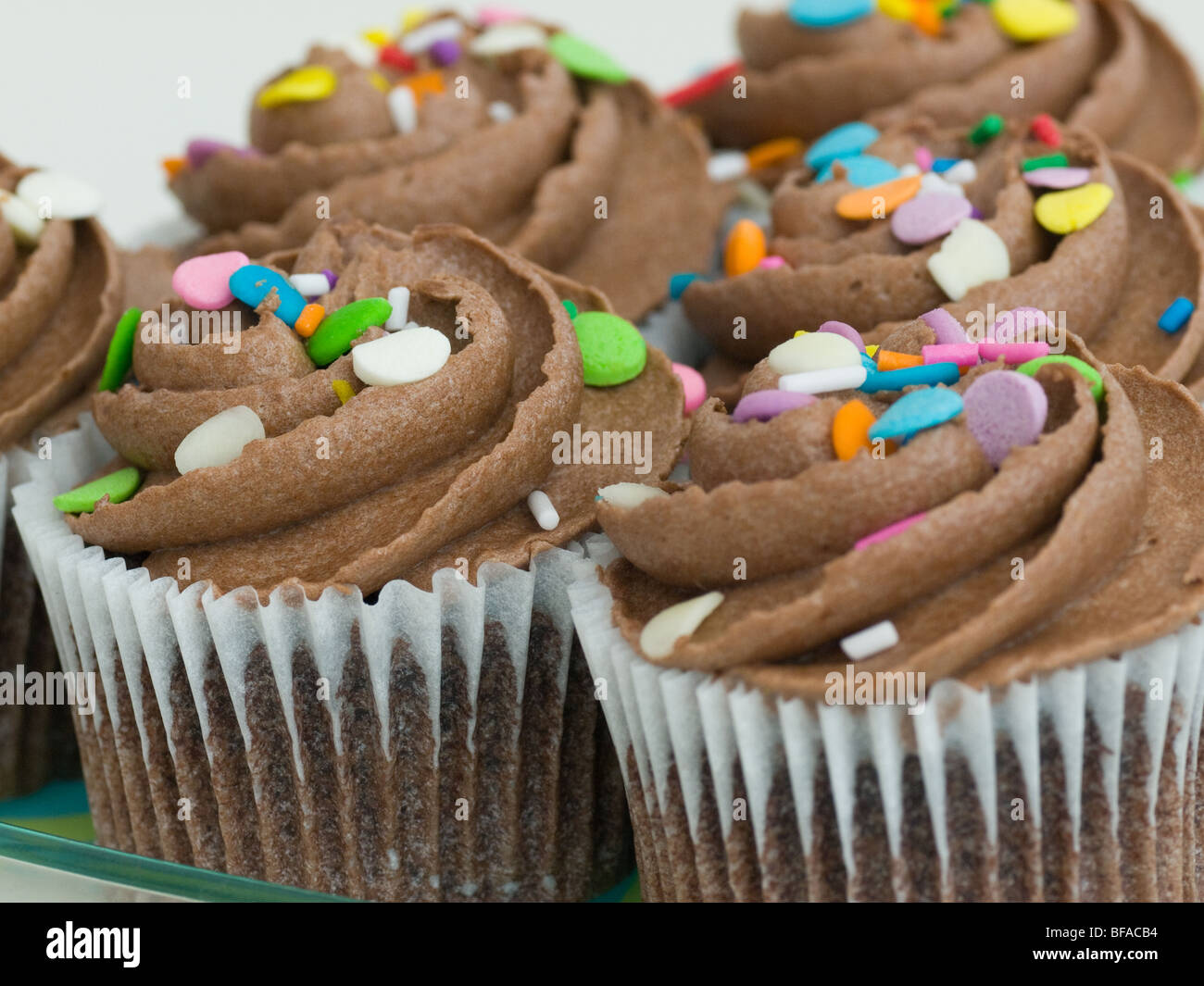 Yummy chocolate cupcakes with sprinkles. Stock Photo