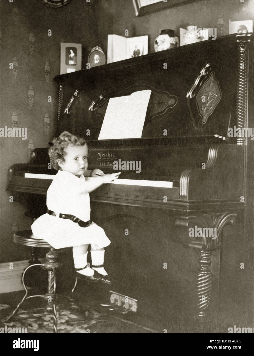 Infant Playing Upright Piano Stock Photo