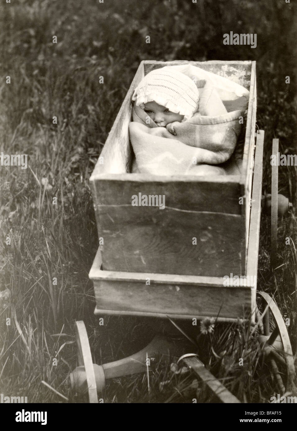 Infant Tightly Packed in Toy Wagon Stock Photo