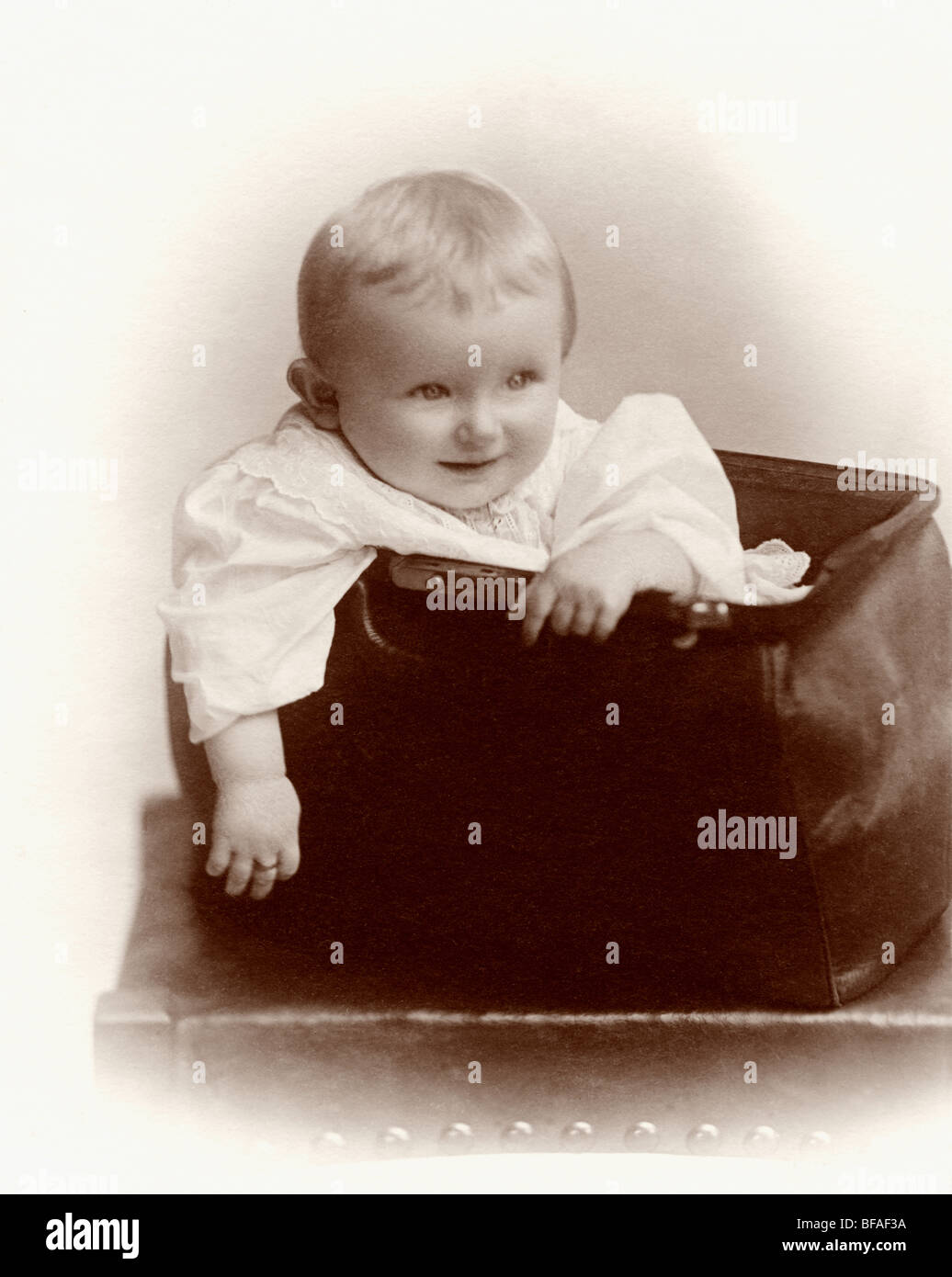 Tiny Infant Boy on Giant Rocking Chair Stock Photo
