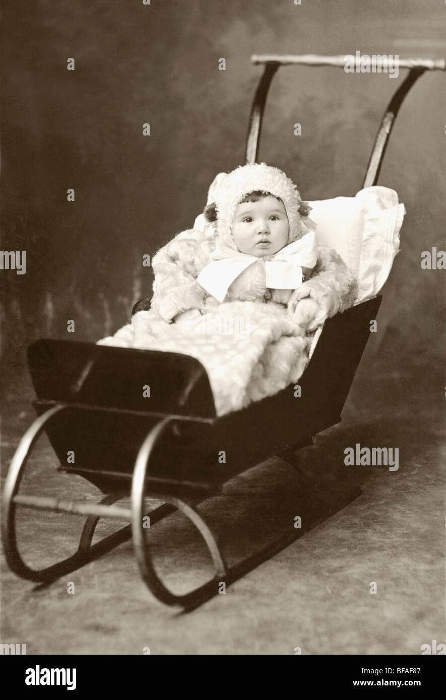 Cozy Infant in Sleigh Baby Carriage Stock Photo