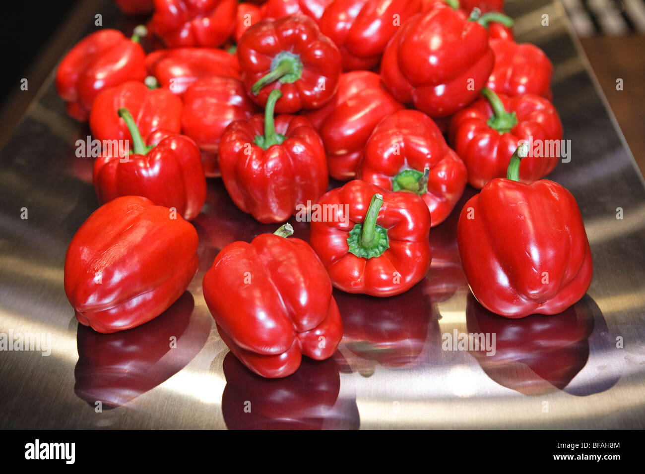 Red bell peppers on metal scoop Stock Photo