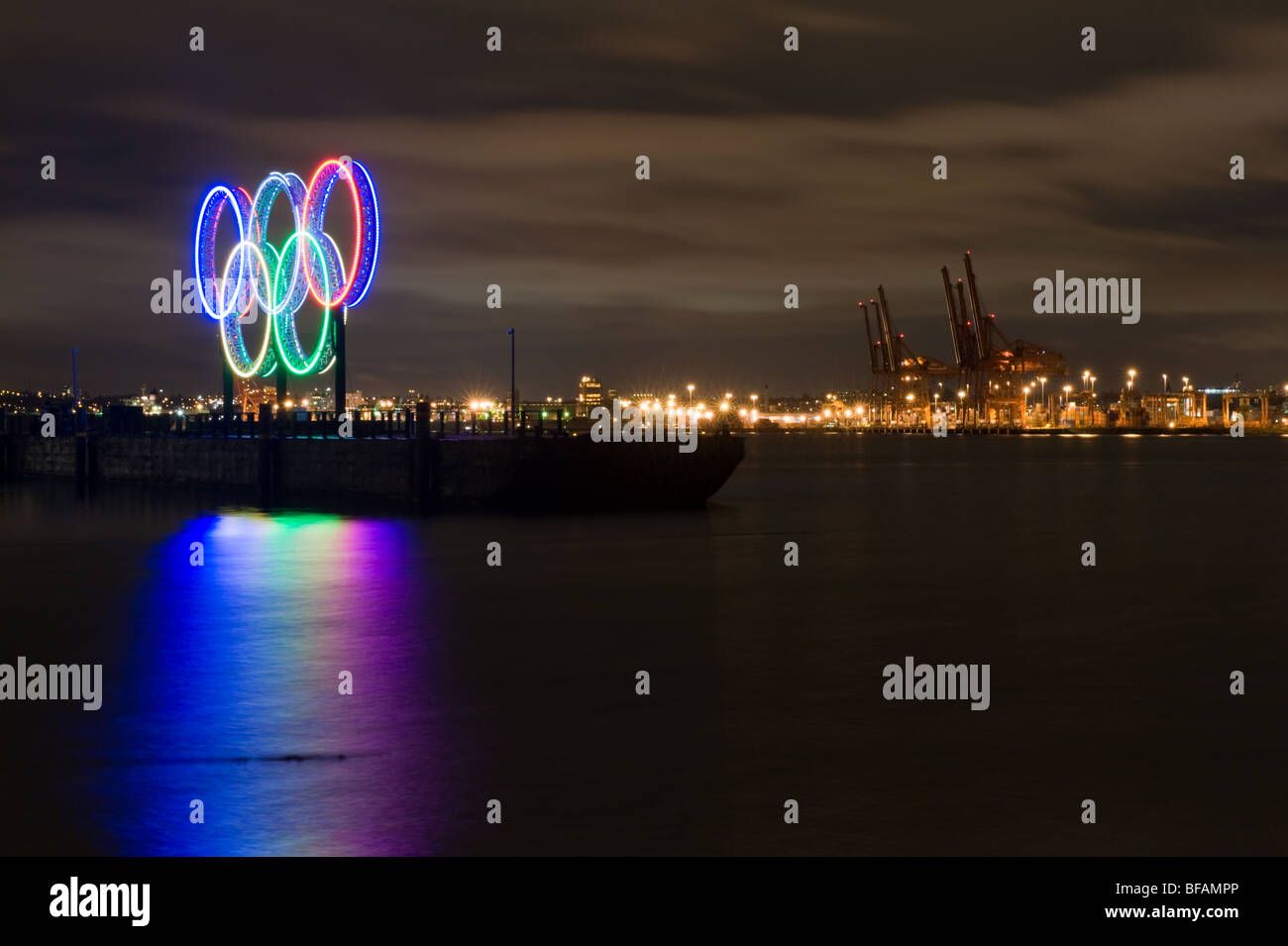 olympic rings in Vancouver at night with shipping port in back ground Stock Photo
