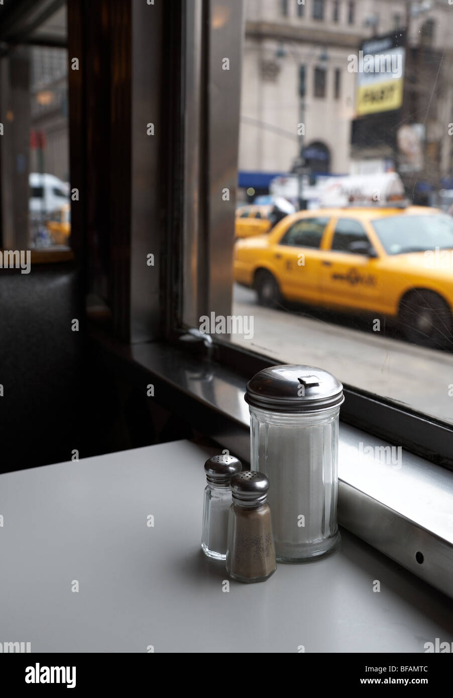 View out of a diner window with parked taxis outside. Stock Photo