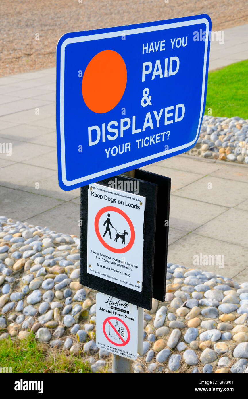 Hastings, East Sussex, England, UK. Signpost with Pay and Display; Keep Dogs on Leads; Alcohol-free Zone Stock Photo