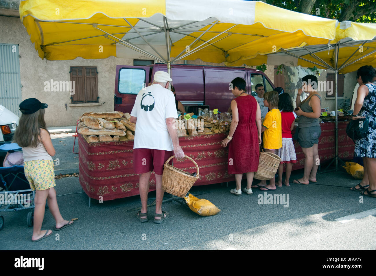 Buying bread at a market stall in Régusse village,Provence,South of France Stock Photo