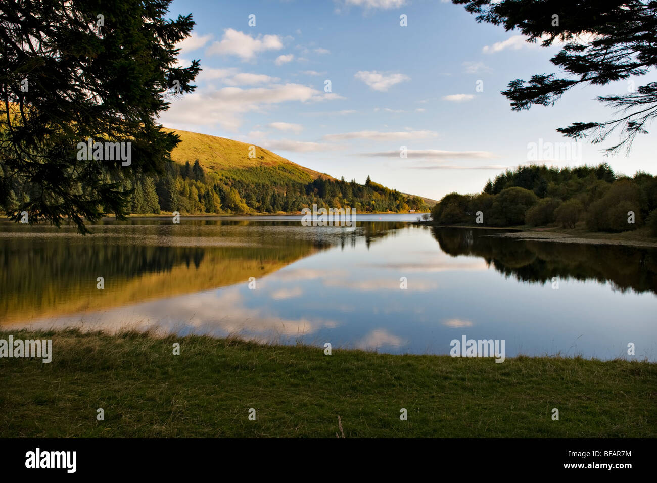 Pontsticill Reservoir (known locally as Dolygaer Lake) in the Brecon Beacons in Mid-Wales early evening with reflection Stock Photo