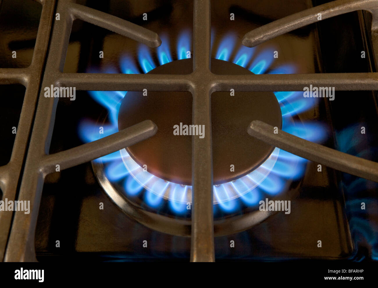 A stove-top gas burner with its blue flames Stock Photo