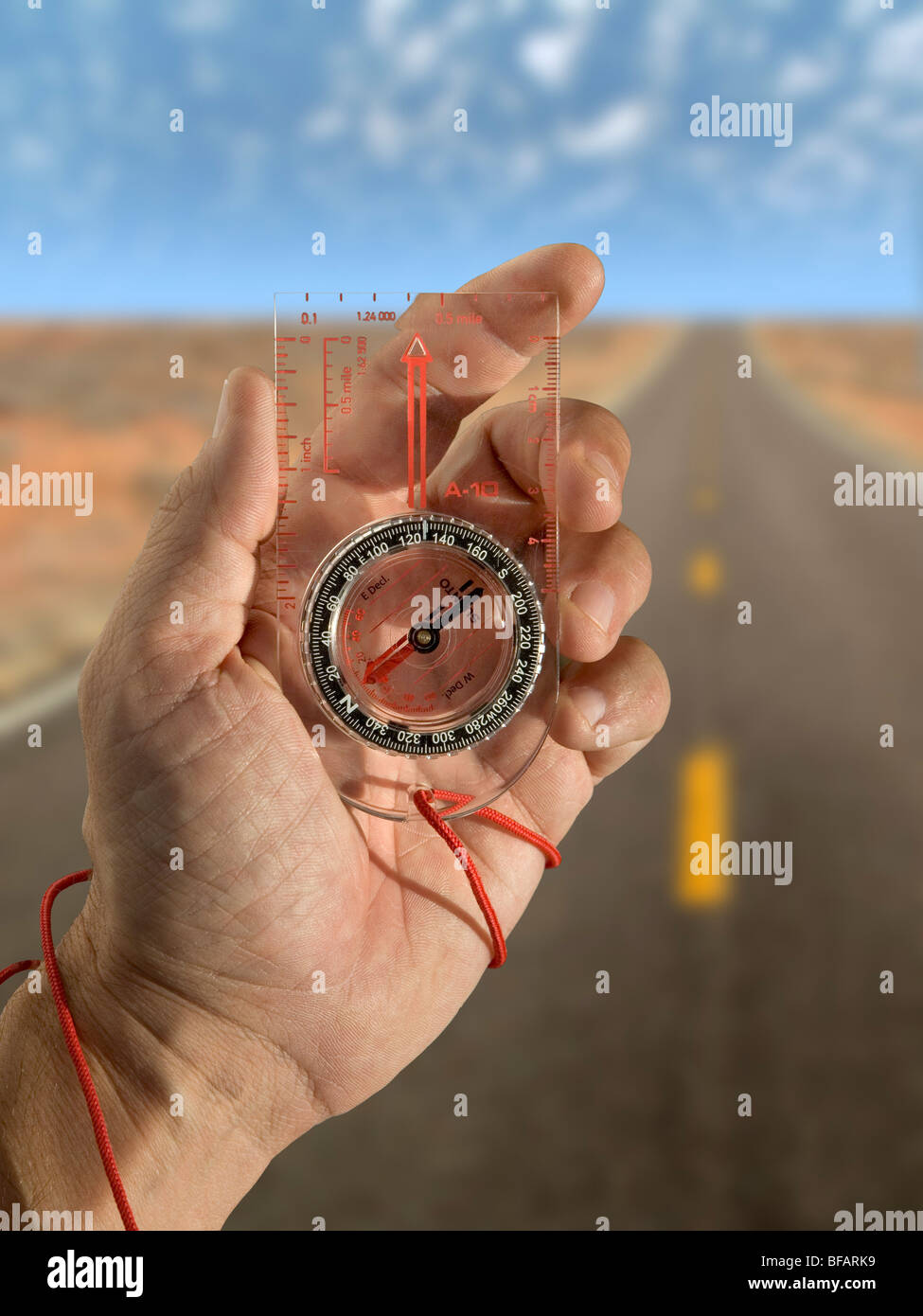 Looking at a hiking compass while walking Stock Photo Alamy