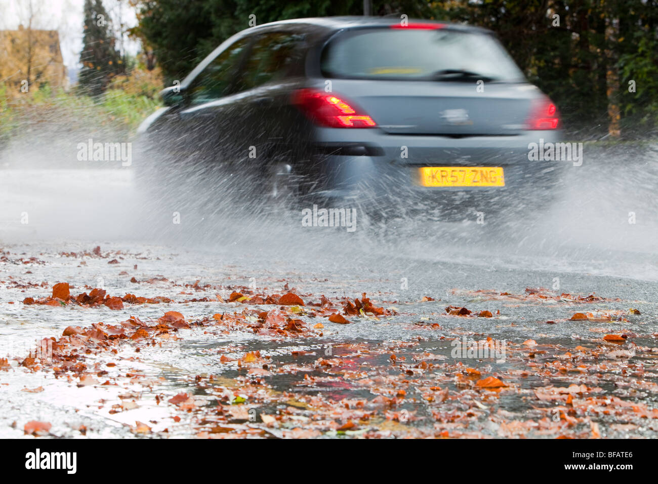 Traffic driving through flood water in Ambleside, Cumbria, UK Stock