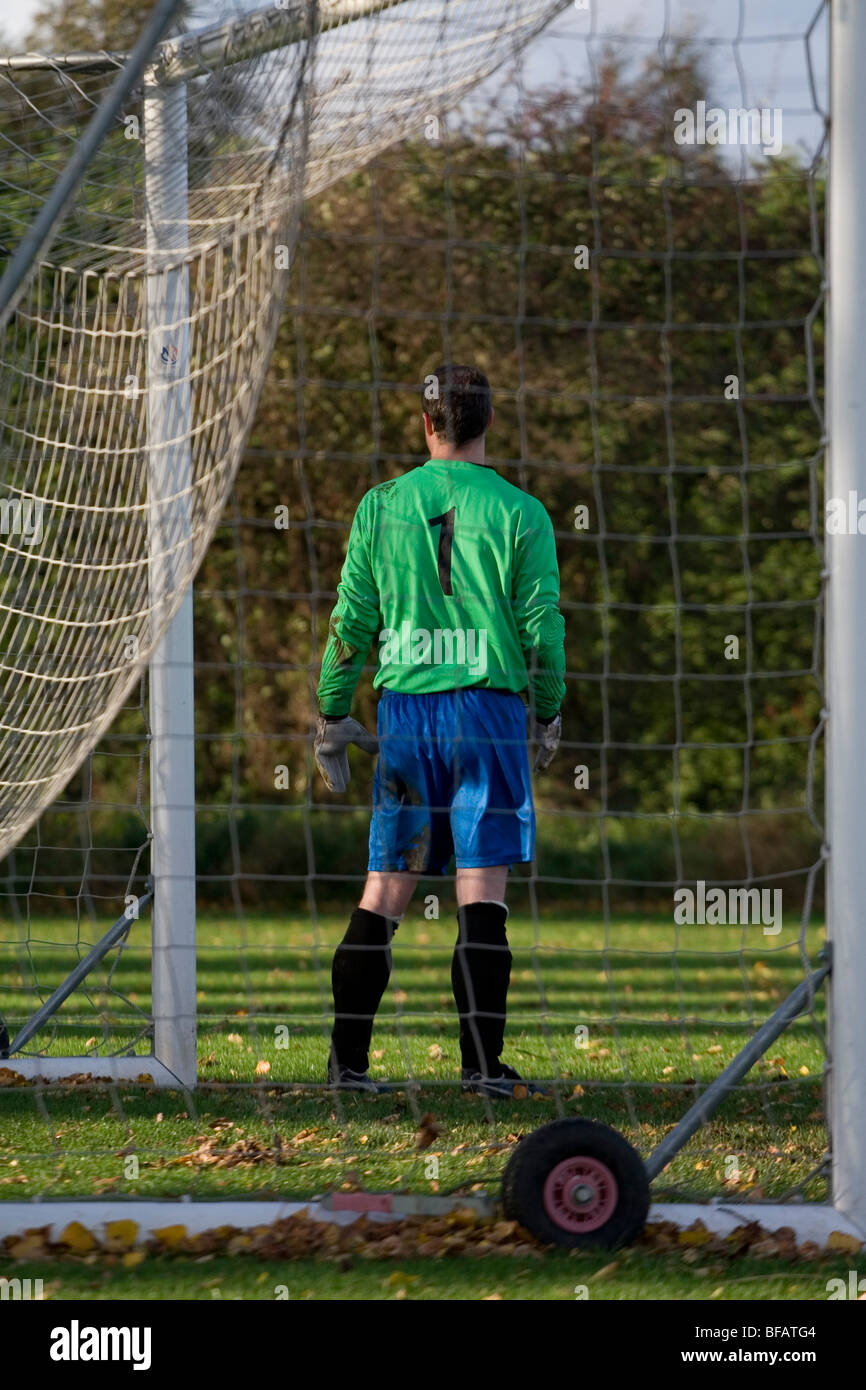 A football (soccer) goalkeeper standing guard in his goal Stock Photo