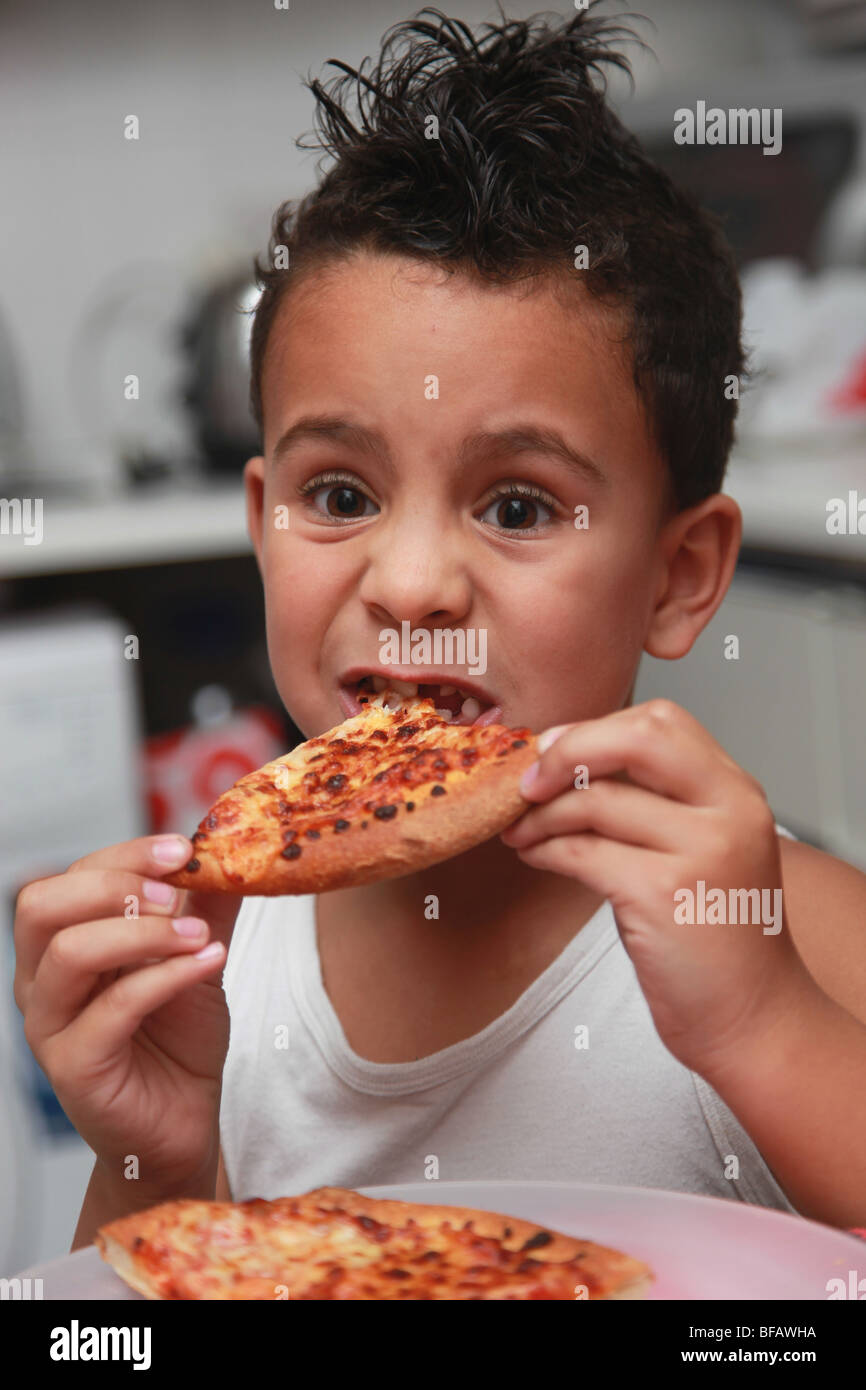 6 year old boy eating pizza Stock Photo Alamy