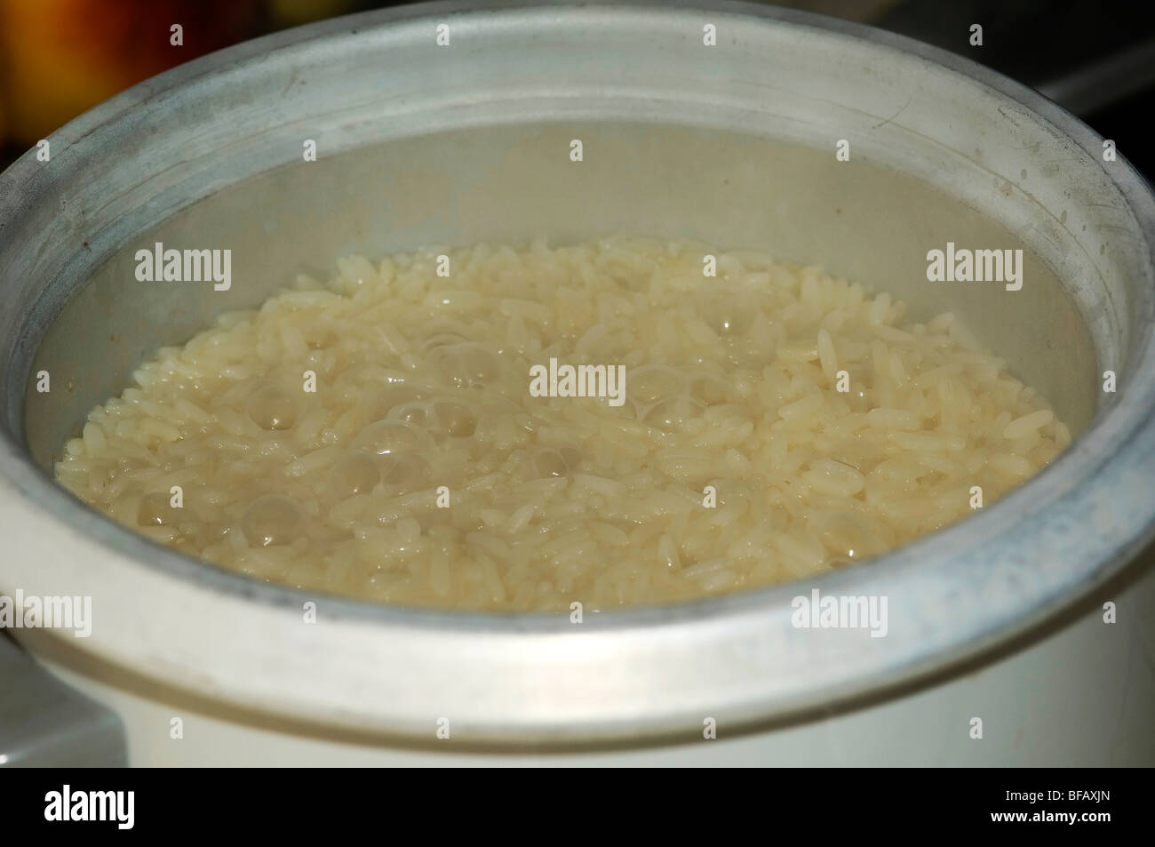 Rice cooker kitchen showing boiling water and rice Stock Photo Alamy