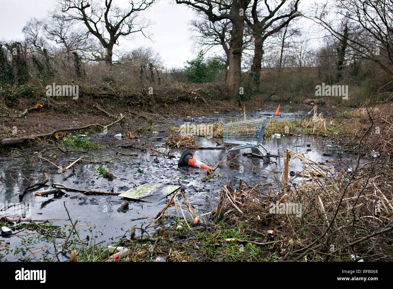 Rubbish thats been dumped on a frozen local duck pond by hooligans Stock Photo