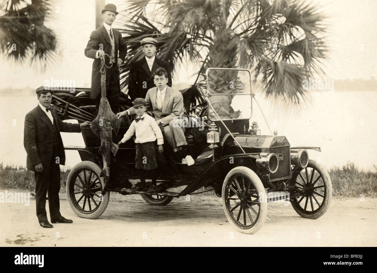 Fisherman in Model T Ford Holding Up Sawfish Stock Photo
