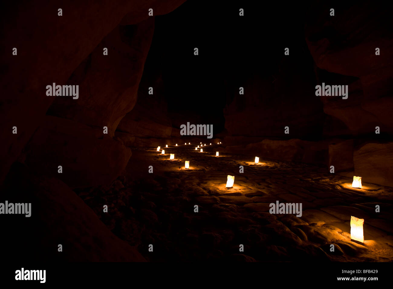 The Siq leading to the Treasury at Petra by night, Jordan Stock Photo