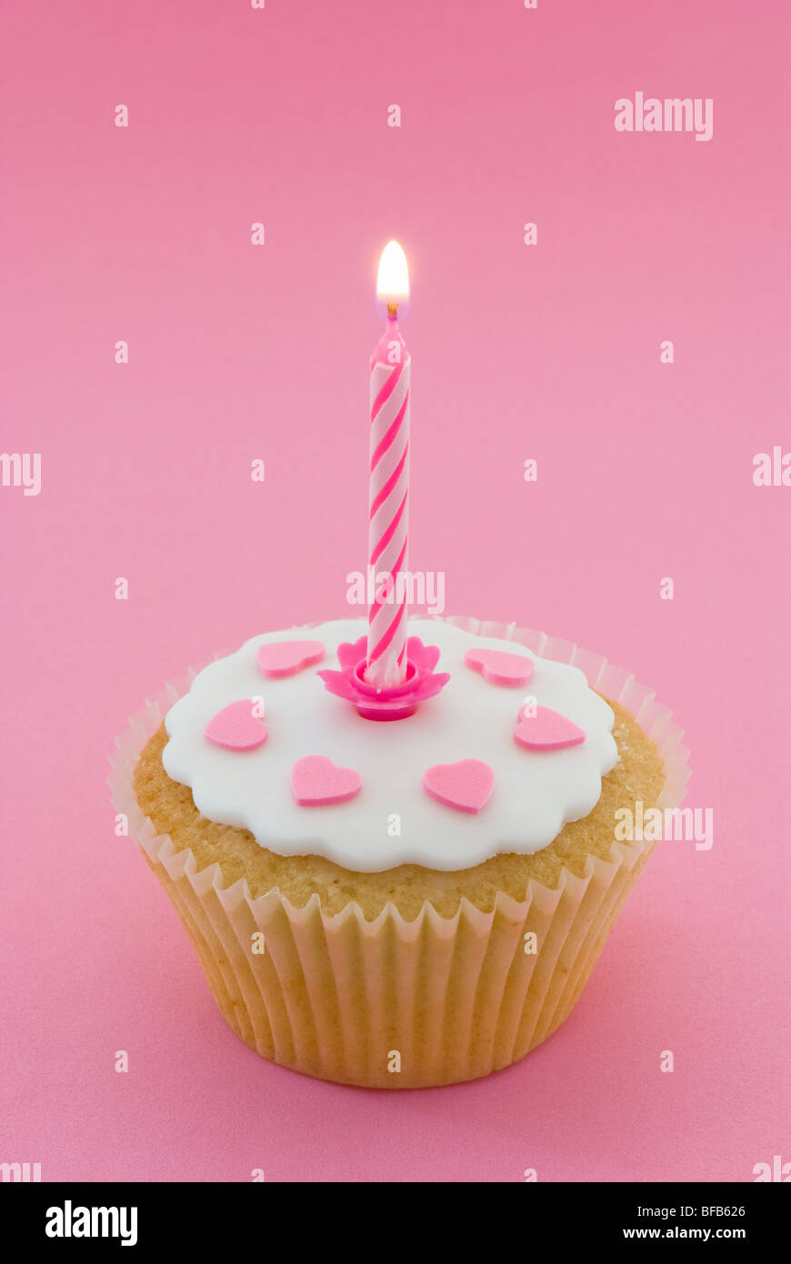Single cupcake with lit candle Stock Photo