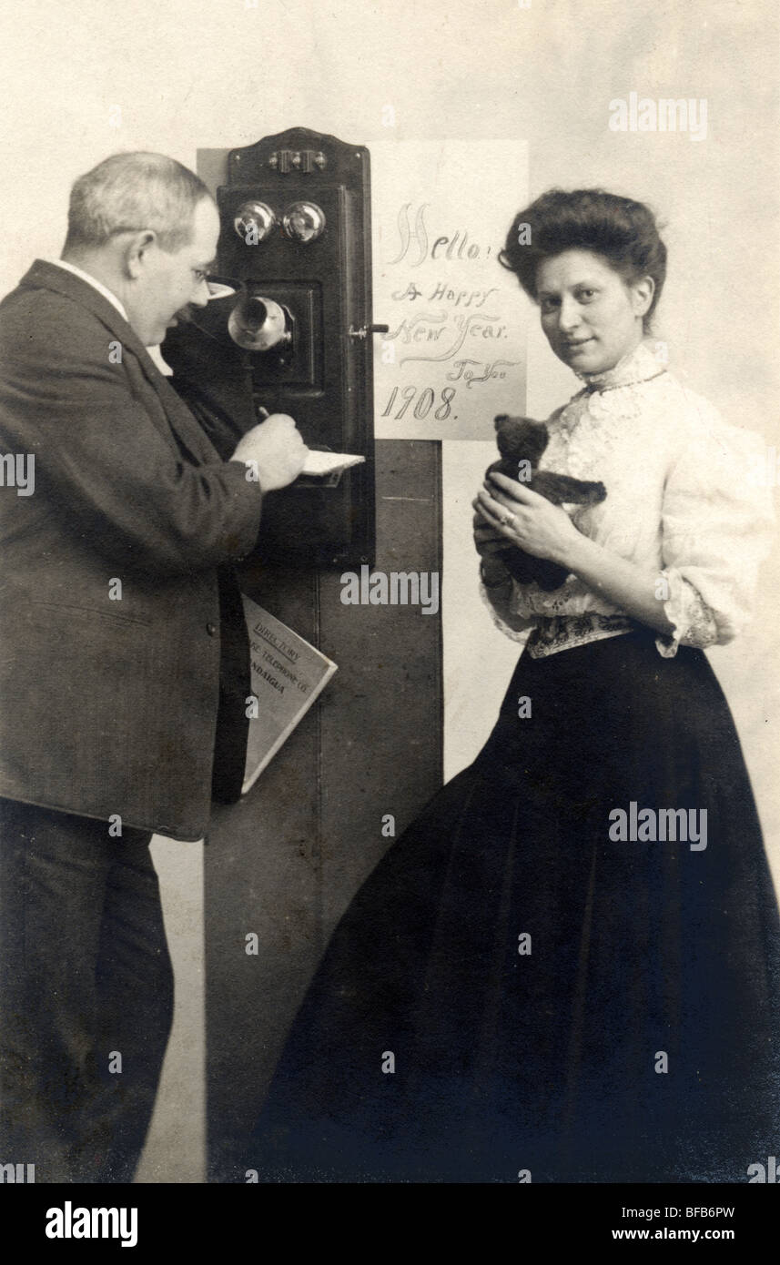 Couple on Wall Telephone with Teddy Bear Stock Photo