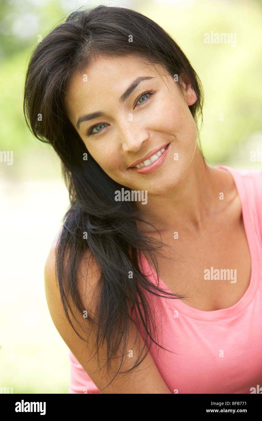 Portrait Of Young Woman In Park Stock Photo - Alamy